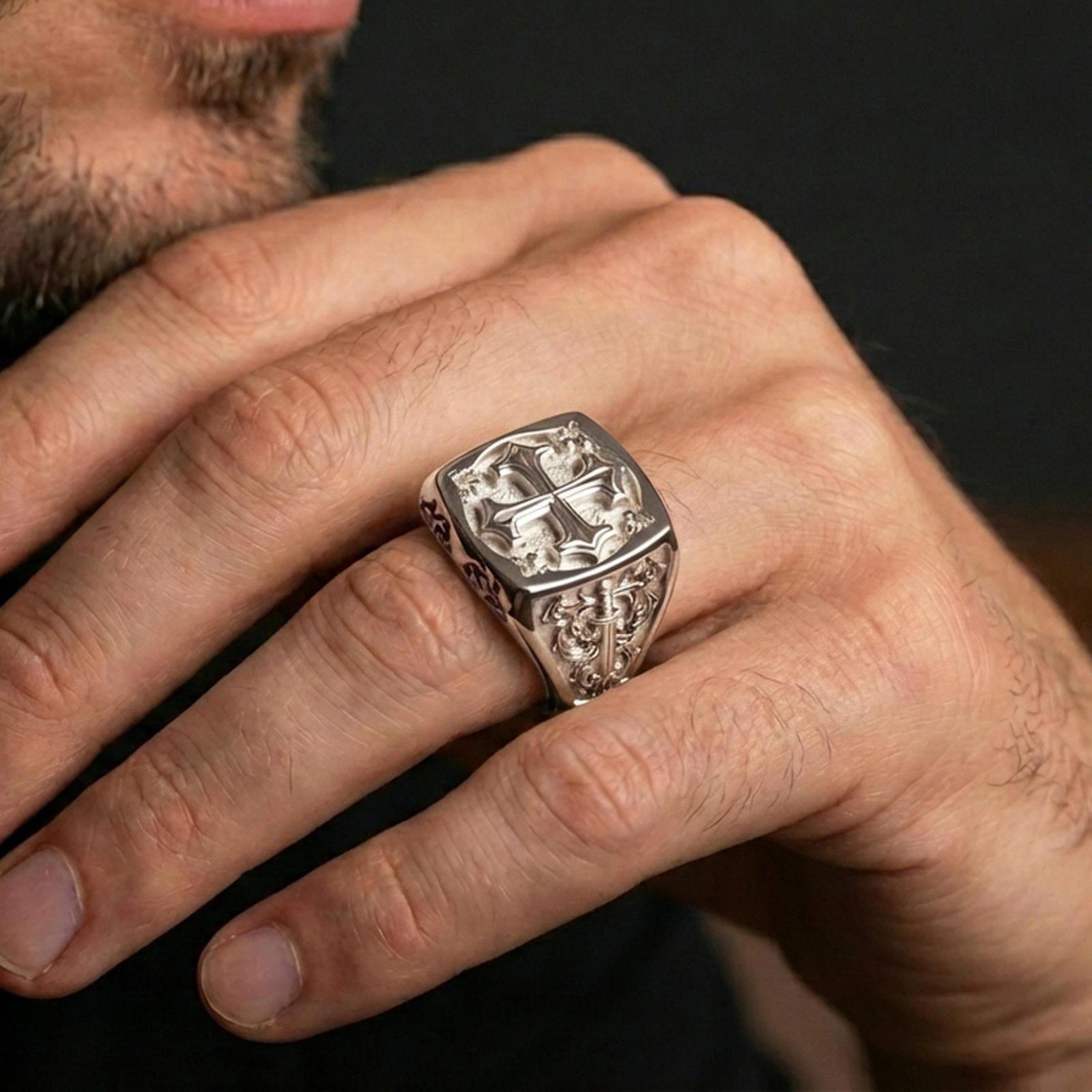 Polished silver crusader cross ring worn on finger, engraved Christian signet style, premium religious accessory