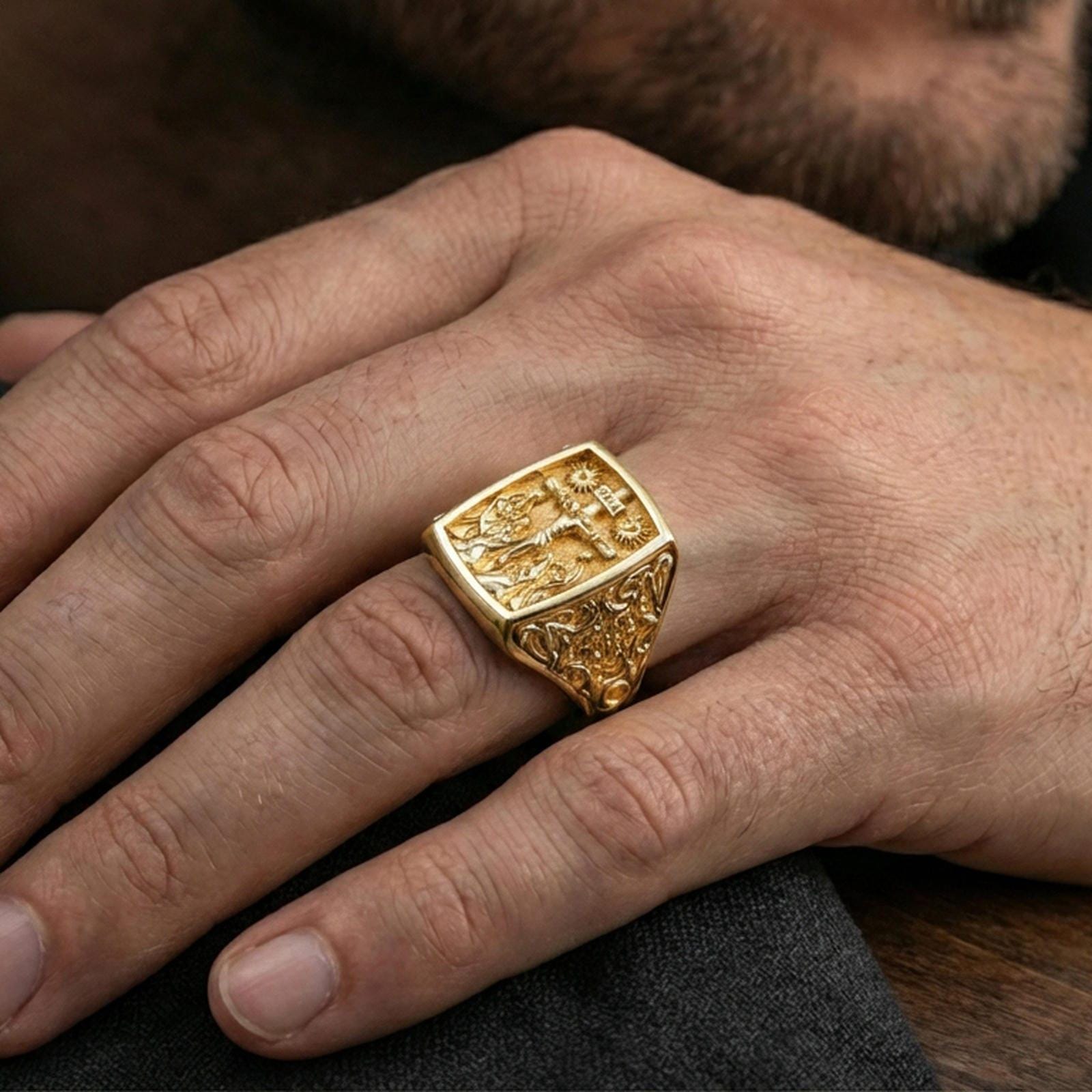 Gold plated INRI crucifix signet ring worn on finger, raised Jesus cross relief, bold religious statement accessory
