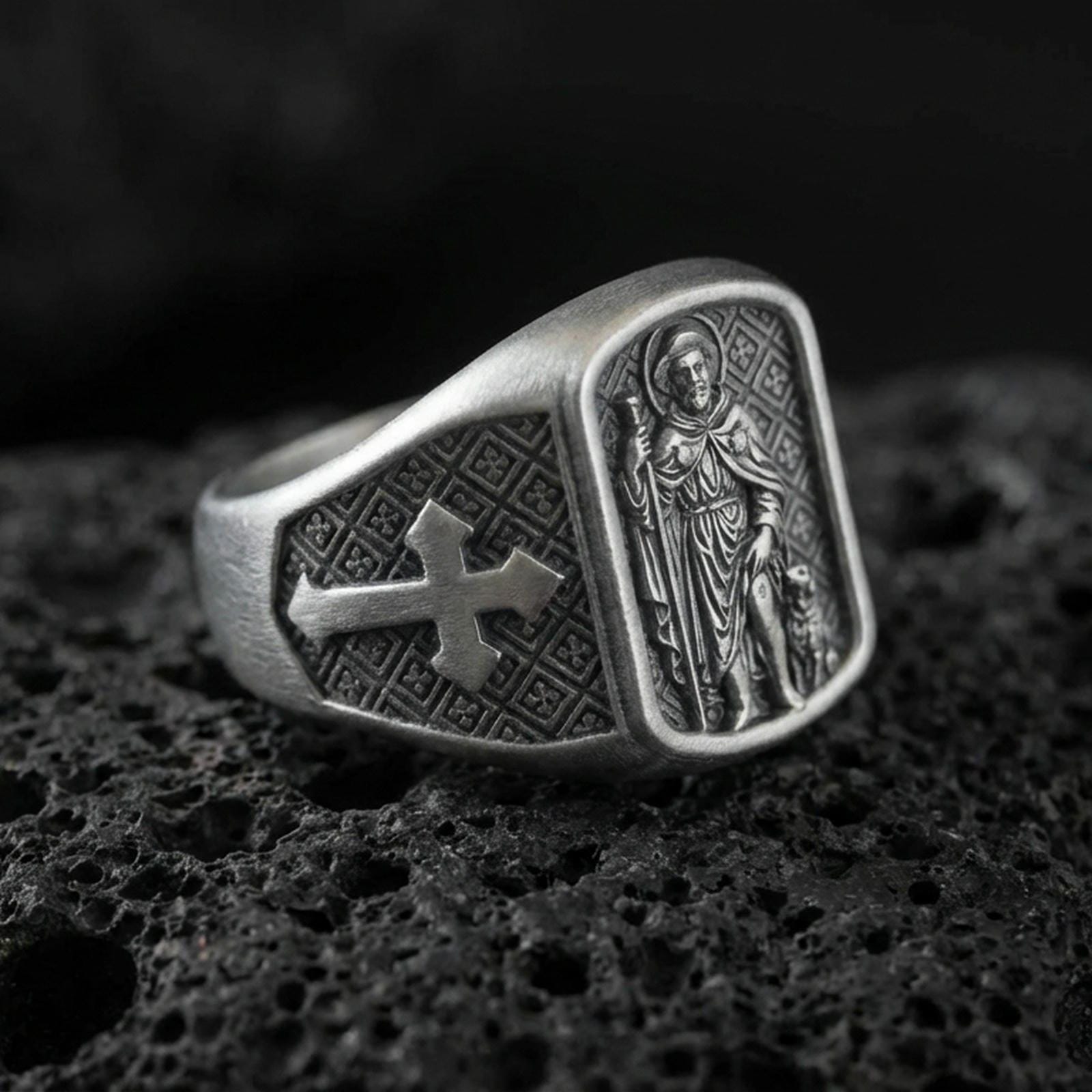Oxidized 925 sterling silver Saint Roch signet ring on volcanic rock, patron saint relief with dog figure, cross shoulder details