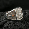 Load image into Gallery viewer, Polished silver Saint Roch signet ring on porous volcanic stone, religious saint medal relief, protection and healing symbol design
