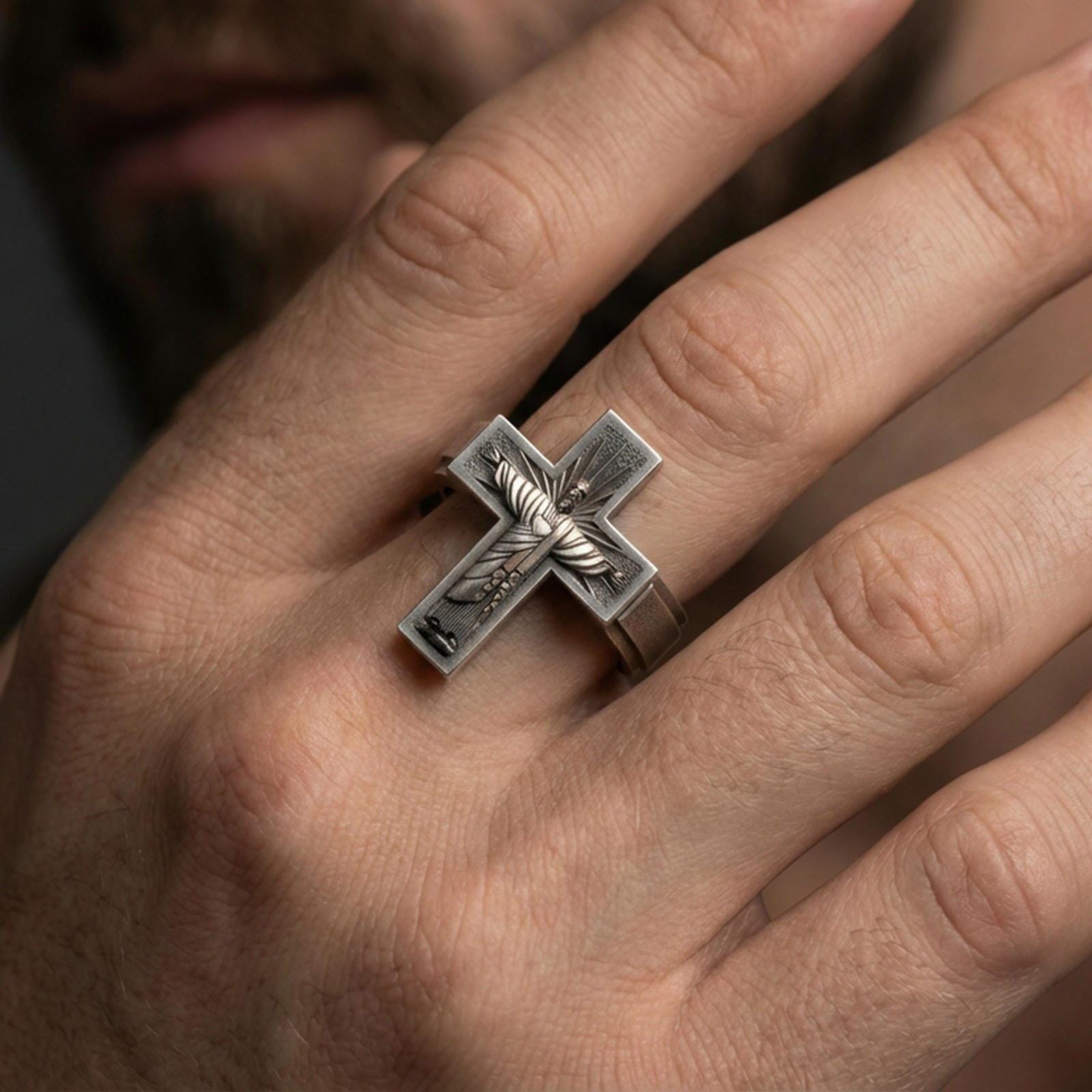 Oxidized 925 sterling silver crucifix ring worn on finger, Jesus on cross relief, bold Christian faith ring style