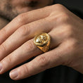 Load image into Gallery viewer, Gold plated Sacred Heart signet ring worn on finger, flaming heart cross motif, religious statement ring for men
