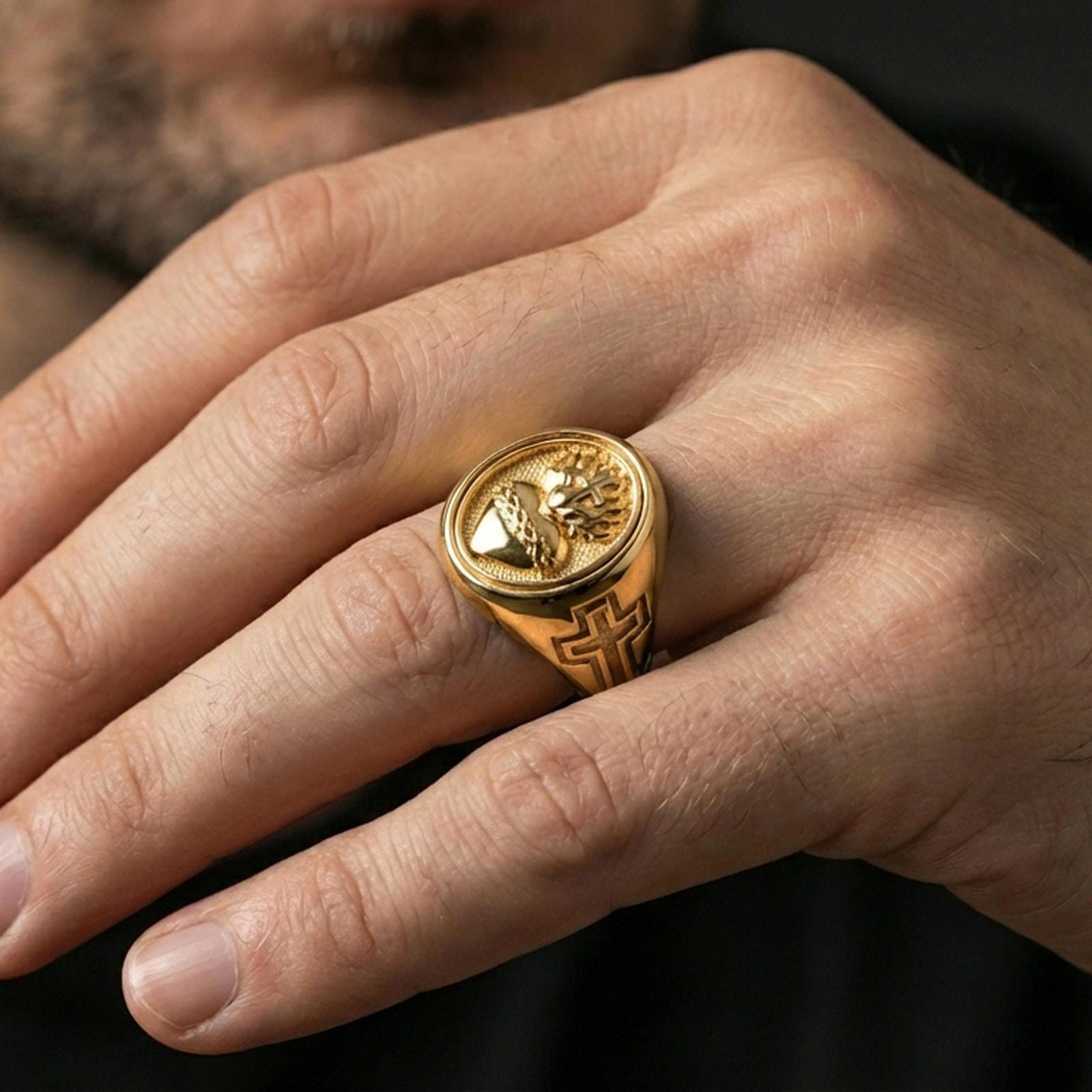 Gold plated Sacred Heart signet ring worn on finger, flaming heart cross motif, religious statement ring for men