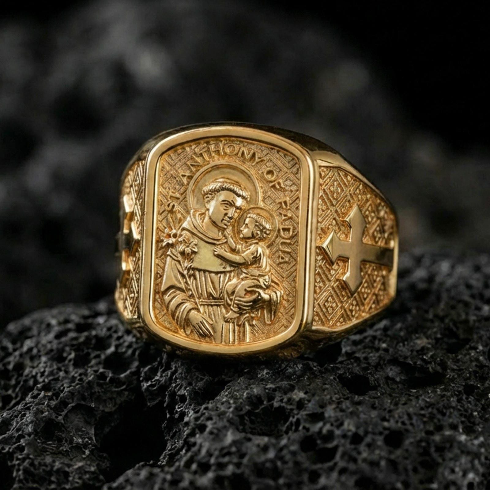 Gold plated Saint Anthony of Padua signet ring on dark volcanic rock, saint and Child Jesus engraving, Catholic religious gift ring