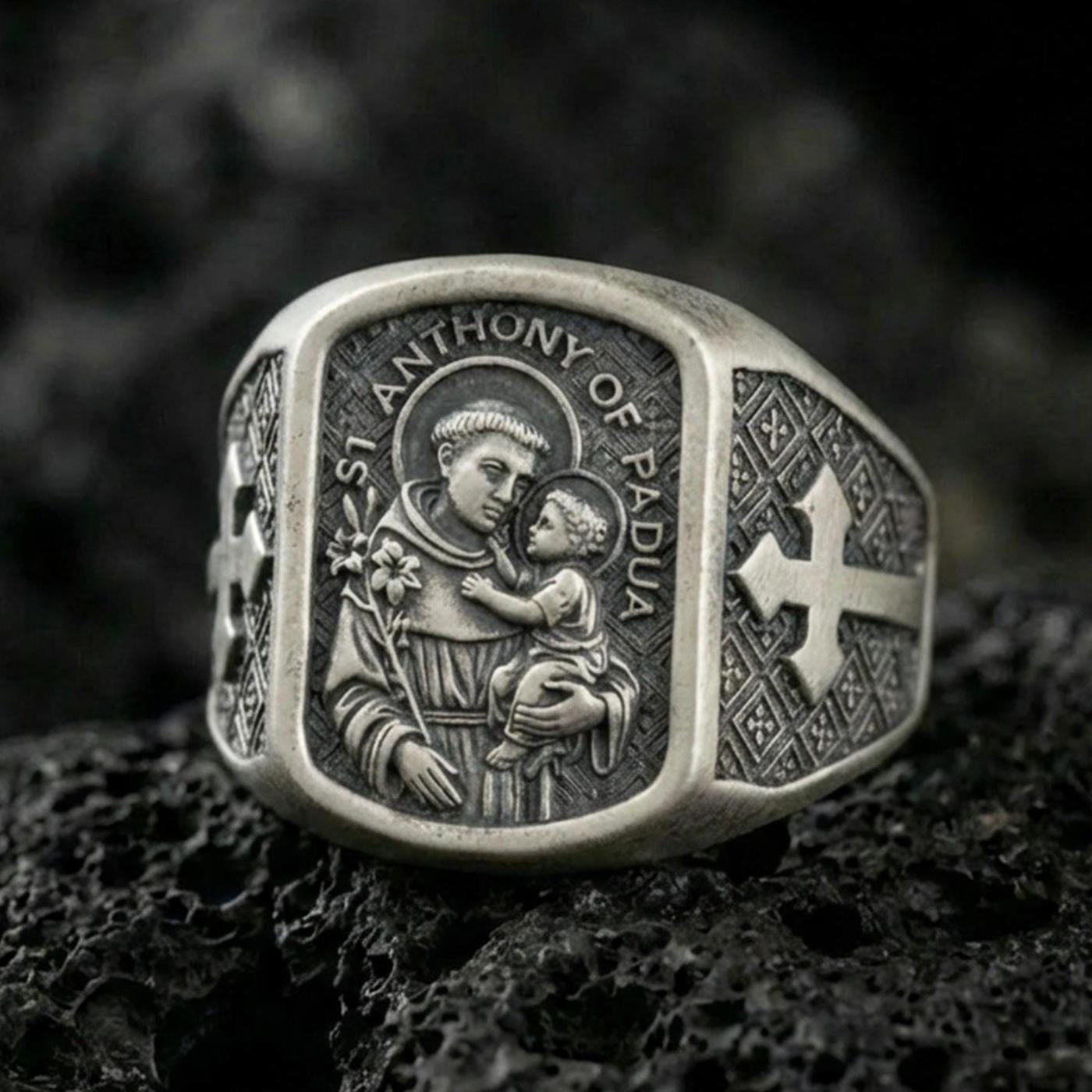 Oxidized 925 sterling silver Saint Anthony of Padua signet ring on volcanic rock, saint holding Child Jesus, Catholic devotional jewelry