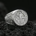 Load image into Gallery viewer, Polished silver St Benedict medal signet ring on porous volcanic stone, engraved saint figure and inscription, Christian faith jewelry
