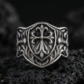 Load image into Gallery viewer, Oxidized 925 sterling silver heraldic cross shield ring on volcanic rock, ornate fleur-de-lis style cross and baroque engravings
