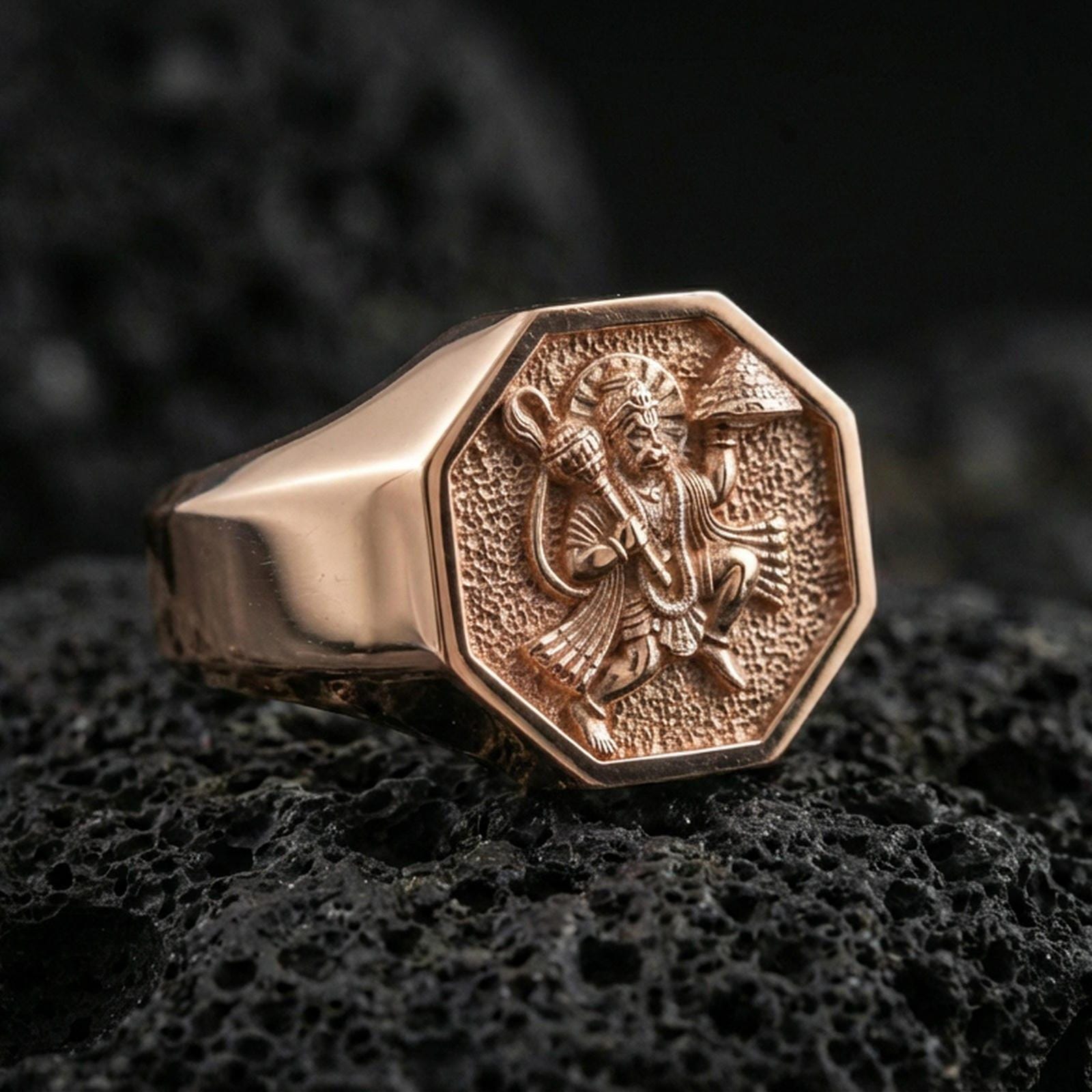Rose gold plated Hanuman signet ring on volcanic stone, detailed Hanuman deity engraving with textured field and signet profile