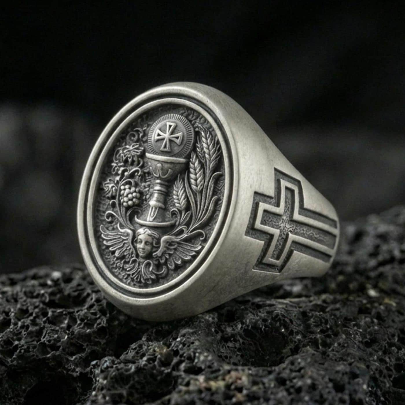 Oxidized 925 sterling silver Holy Eucharist signet ring on volcanic rock, chalice and host engraving with grape and wheat details