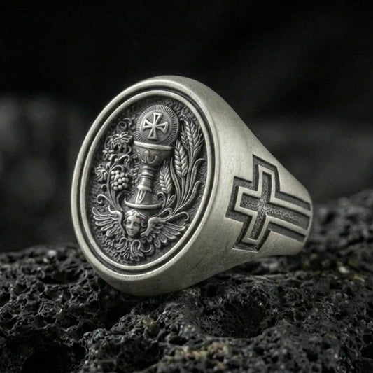 Oxidized 925 sterling silver Holy Eucharist signet ring on volcanic rock, chalice and host engraving with grape and wheat details