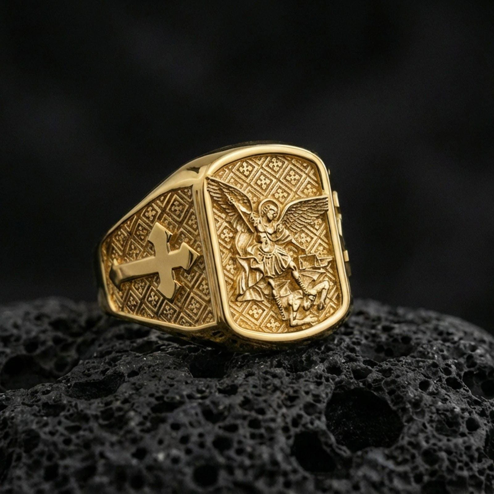 Gold plated Archangel Michael ring on dark volcanic rock, Saint Michael defeating evil relief with bold cross band