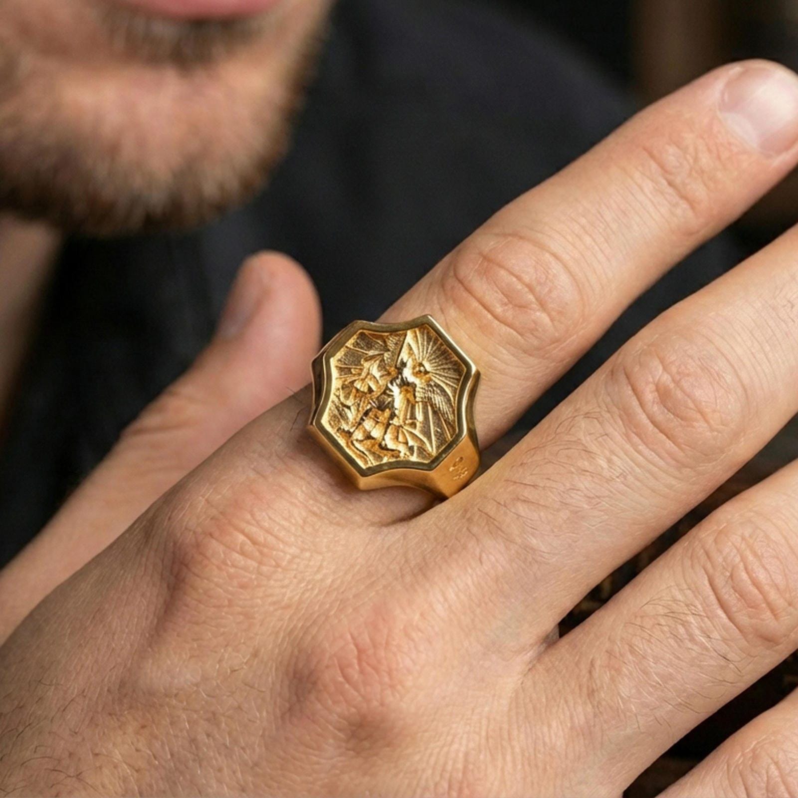 Gold plated Saint Michael ring worn on finger, Archangel warrior relief with “SAINT” side engraving and bold profile