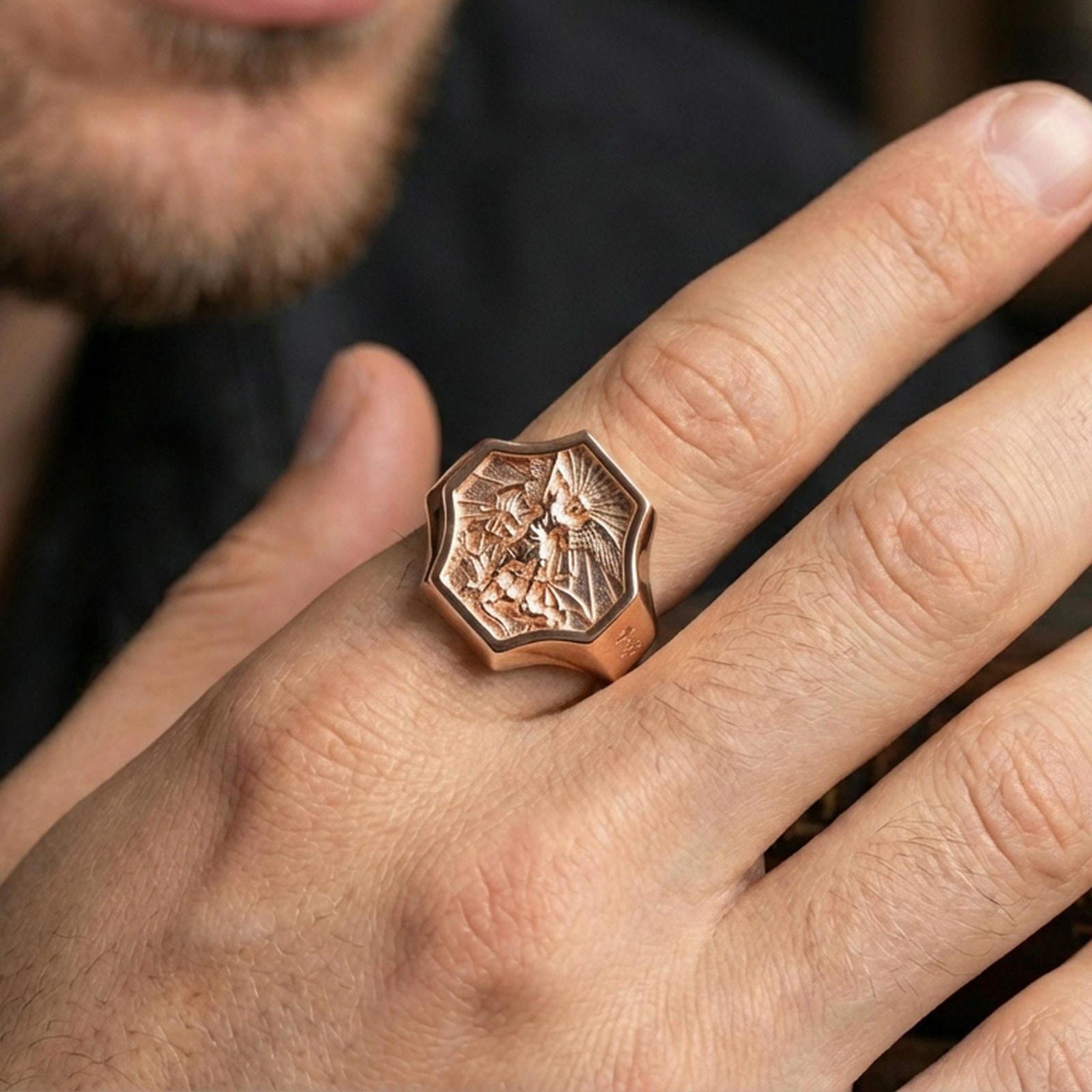 Rose gold plated Saint Michael signet ring worn on finger, octagonal saint seal design with premium warm finish