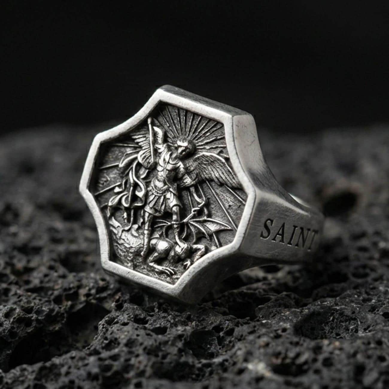 Oxidized 925 sterling silver Saint Michael ring on volcanic rock, octagon signet with Archangel defeating dragon relief