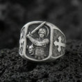 Load image into Gallery viewer, Oxidized Finish silver Saint Michael signet ring on porous volcanic stone, archangel with sword engraving, cross side detail close-up
