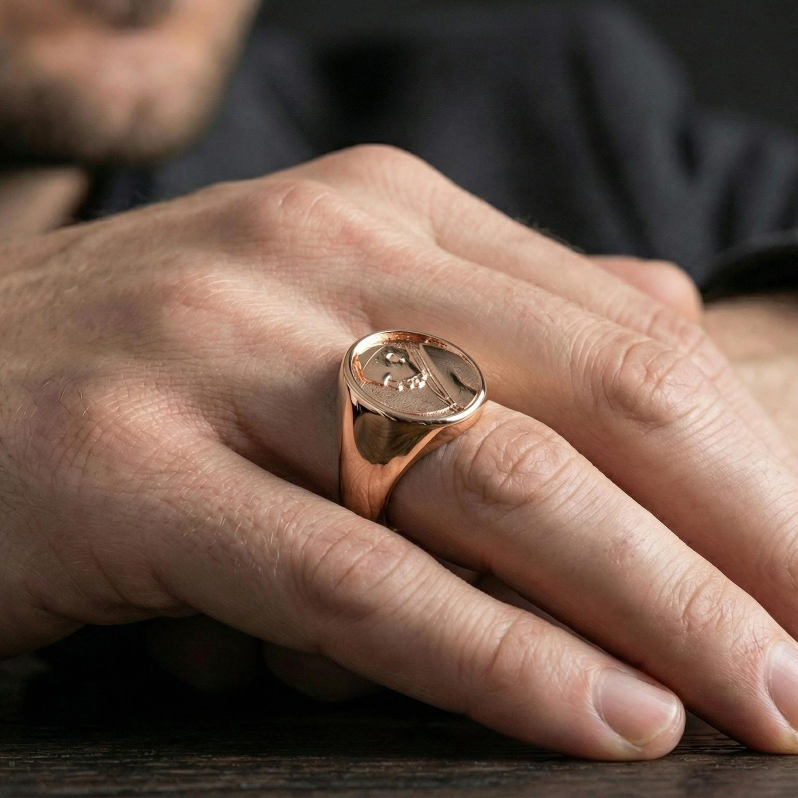 Rose gold plated Pope portrait ring worn on finger, papal profile relief signet with rounded border bezel