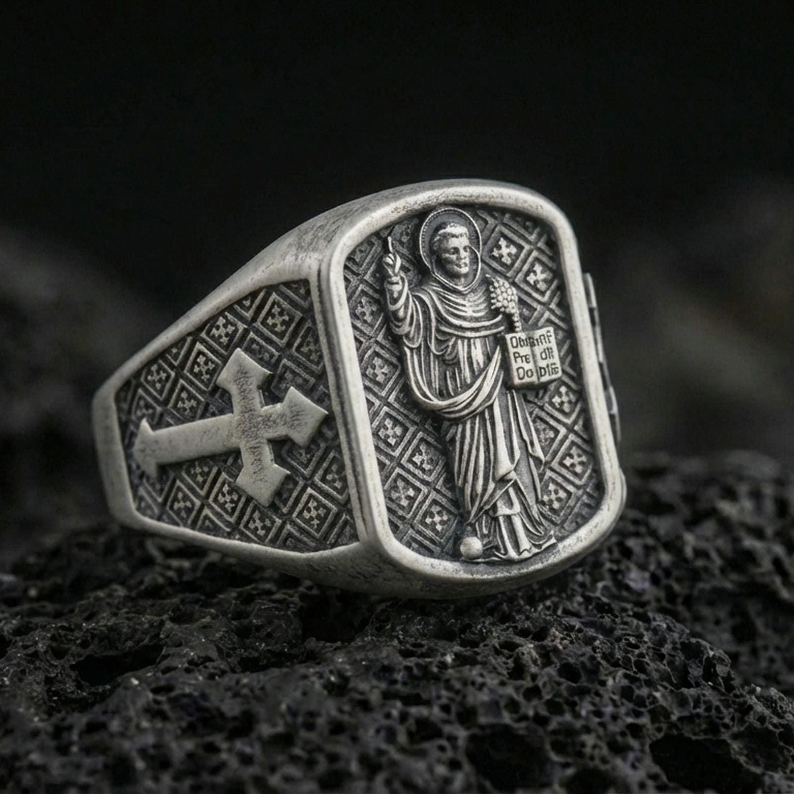 Oxidized 925 sterling silver Saint Dominic signet ring on volcanic rock, preacher saint relief with cross shoulder