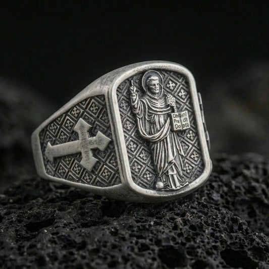 Oxidized 925 sterling silver Saint Dominic signet ring on volcanic rock, preacher saint relief with cross shoulder
