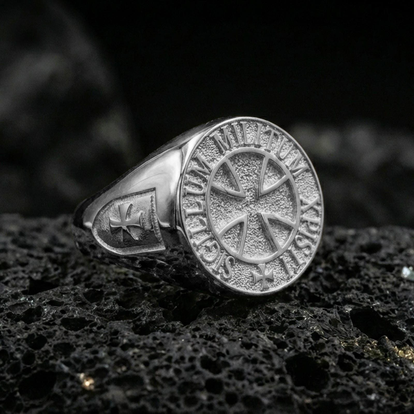 Polished silver Knights Templar ring on porous volcanic stone, templar cross seal with Sigillum Militum text