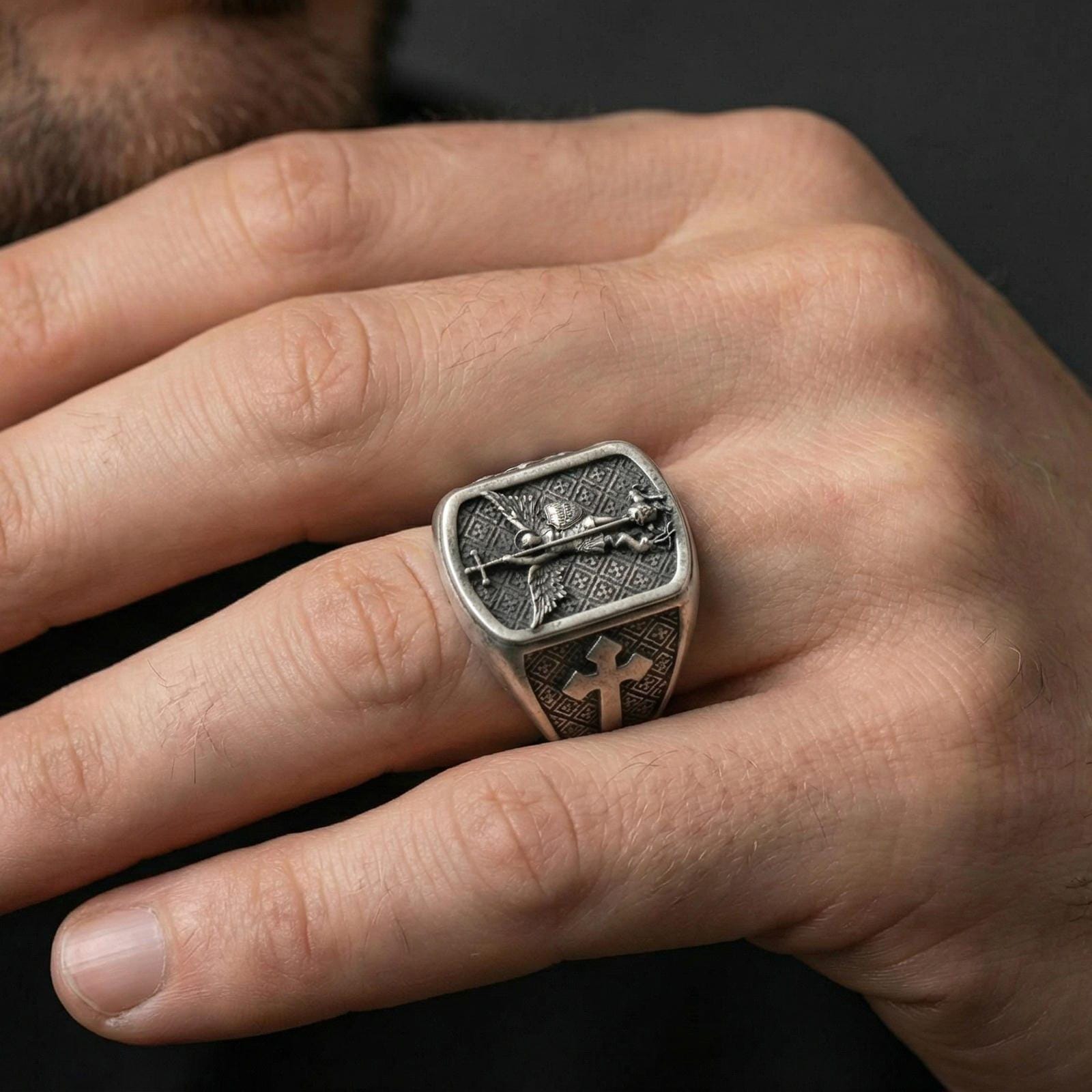 Oxidized 925 sterling silver Saint Michael ring worn on finger, archangel defeating evil relief and cross band