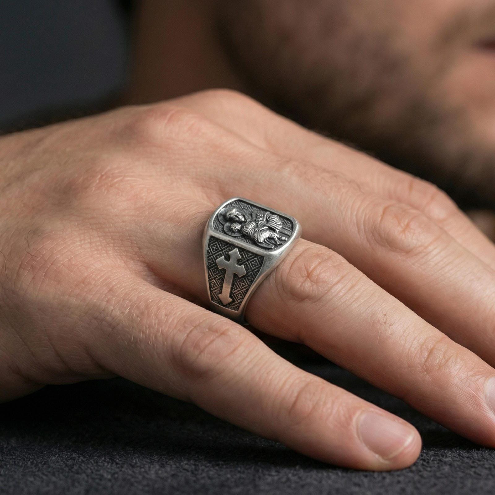 Oxidized 925 sterling silver Saint Anthony ring worn on finger, saint holding Child Jesus relief with cross side panel