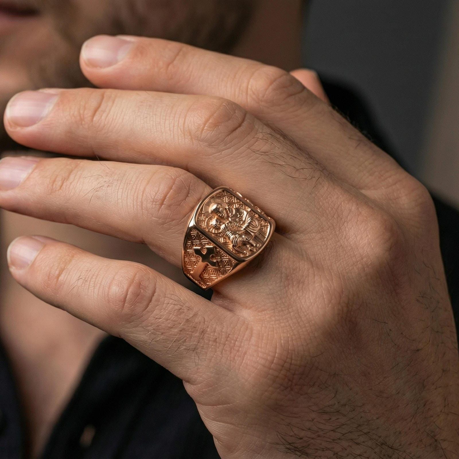 Rose gold plated Saint Anthony signet ring worn on finger, saint and Child Jesus engraving with cross side panel