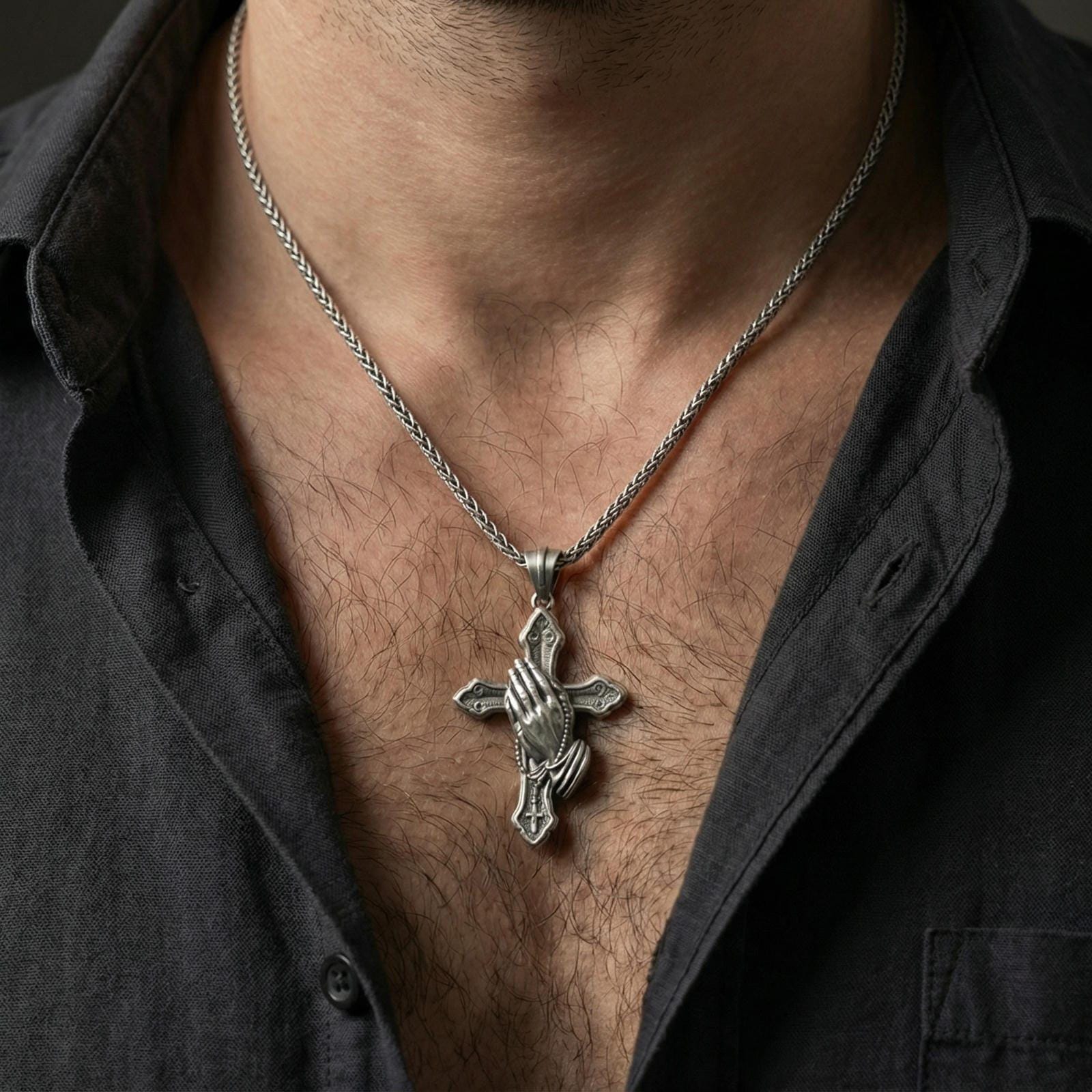 Oxidized praying hands cross pendant necklace worn on neck, lifestyle close-up showing the rosary detail and vintage devotional look