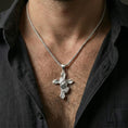Load image into Gallery viewer, Polished silver praying hands cross pendant necklace on neck, natural wear shot highlighting the hand relief and bold faith statement design
