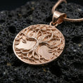 Load image into Gallery viewer, Rose gold plated Tree of Life necklace on dark volcanic stone, Yggdrasil medallion with raised leaf details
