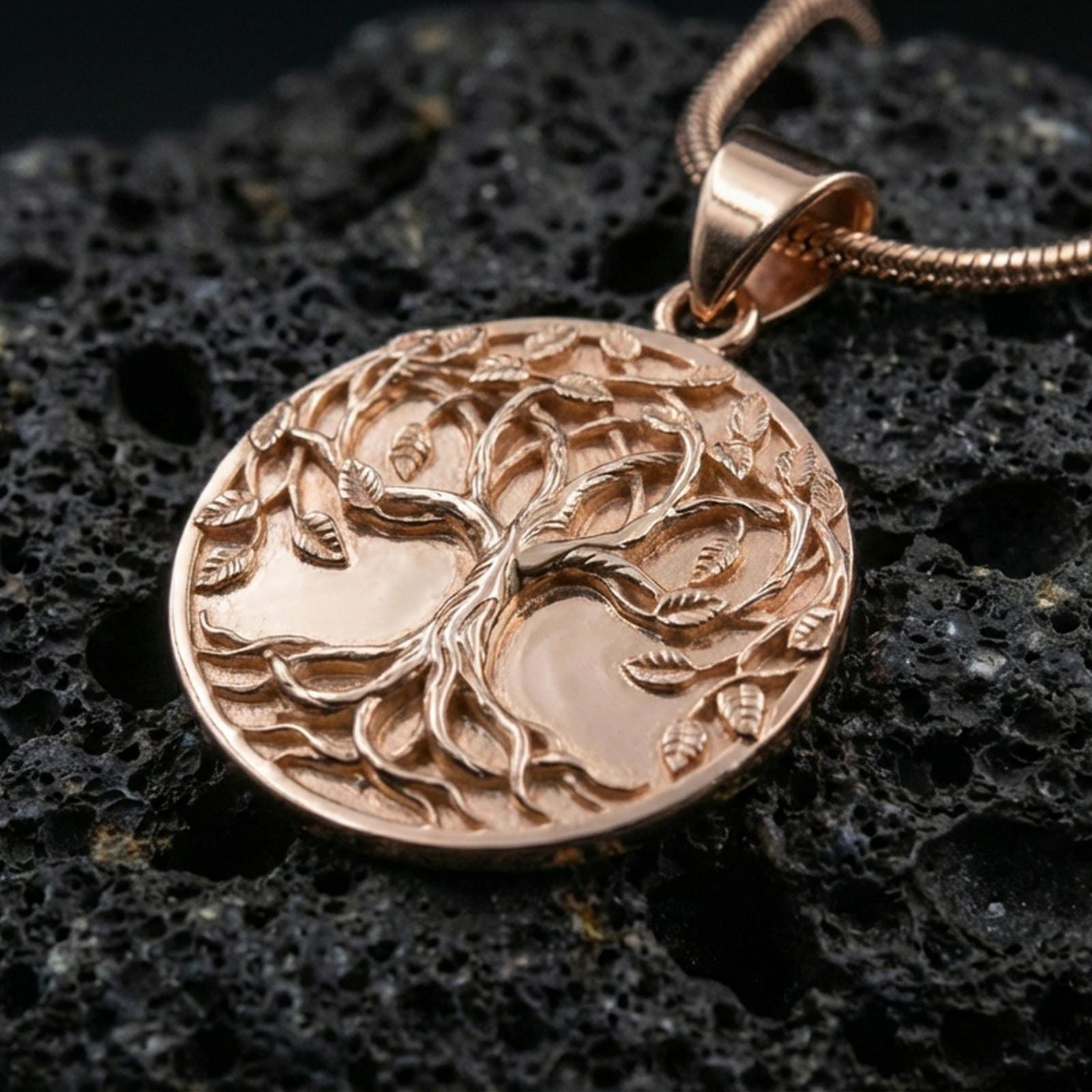 Rose gold plated Tree of Life necklace on dark volcanic stone, Yggdrasil medallion with raised leaf details