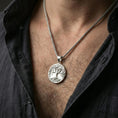 Load image into Gallery viewer, Polished silver Tree of Life necklace worn on neck, Yggdrasil round pendant with detailed branches and roots
