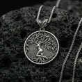 Load image into Gallery viewer, Oxidized 925 sterling silver Yggdrasil tree of life pendant on volcanic rock, Norse mythology circular medallion with braided chain
