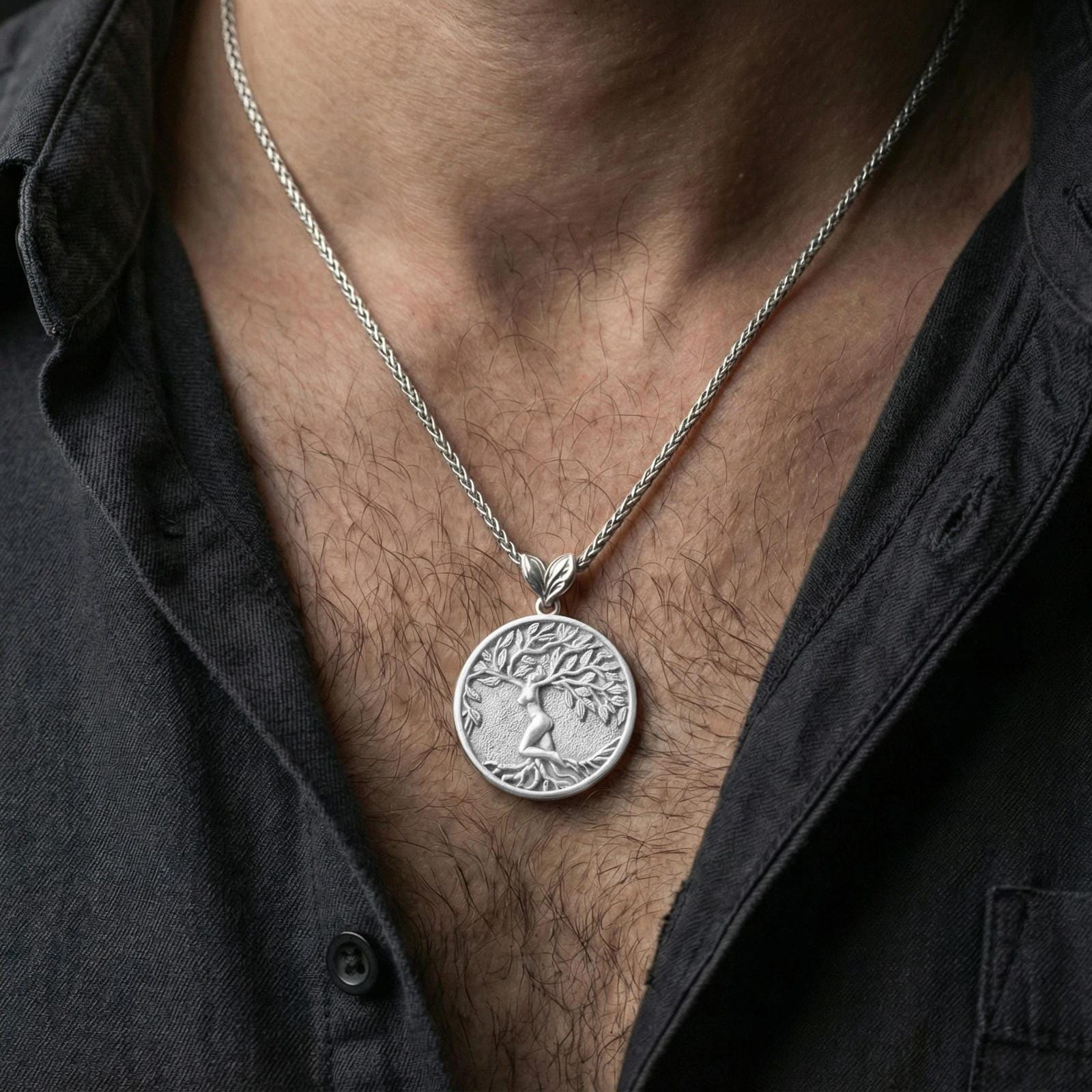 Polished silver Yggdrasil pendant necklace worn on neck, tree of life branches and roots in circular frame