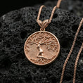 Load image into Gallery viewer, Rose gold plated Yggdrasil pendant necklace on dark volcanic stone, tree of life design in circular frame with leaf bail
