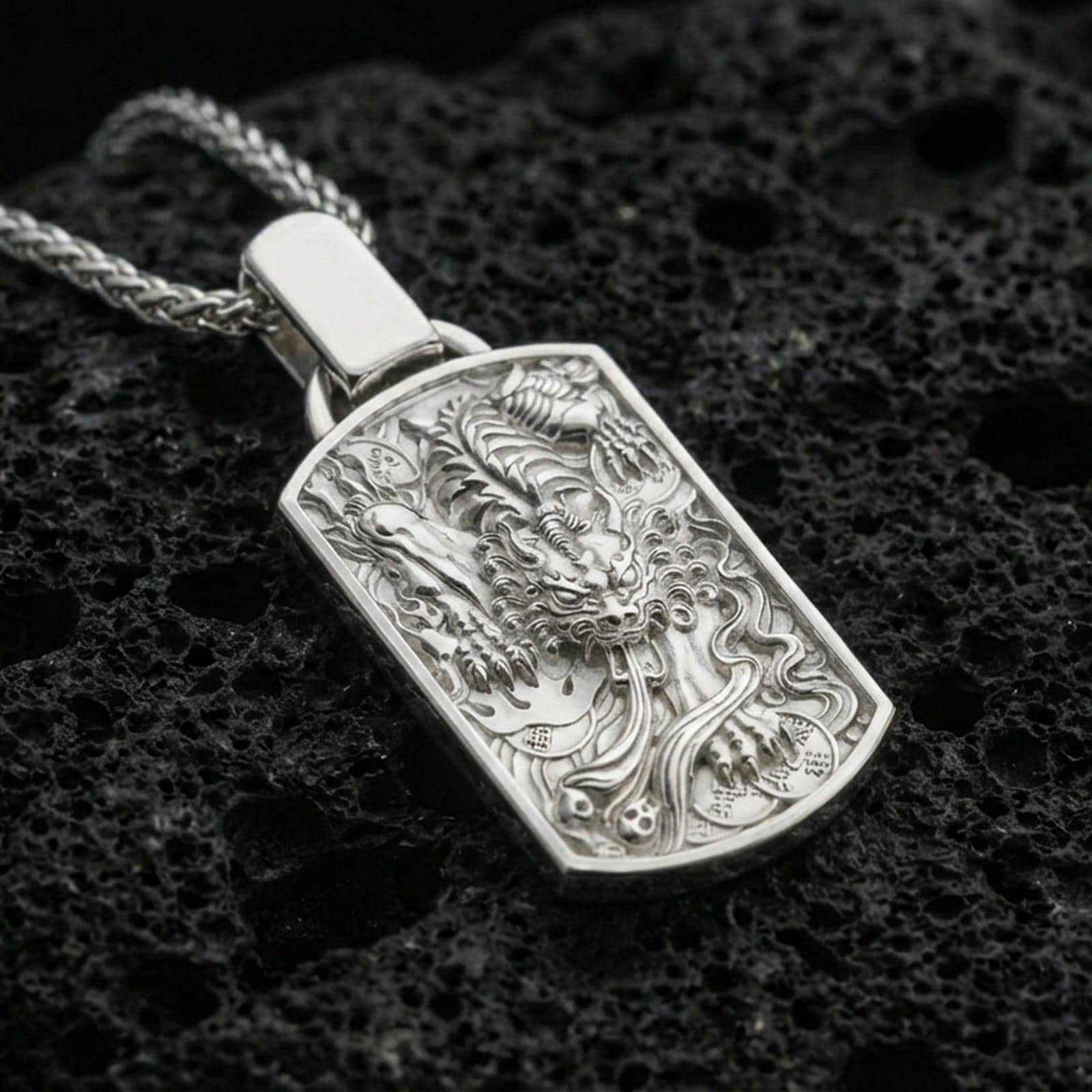 Polished silver foo dog dog tag pendant on porous volcanic stone, detailed Chinese guardian lion talisman necklace