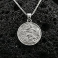 Load image into Gallery viewer, Polished silver Athena coin pendant on porous volcanic stone, Greek goddess warrior medallion necklace with shield and serpent details
