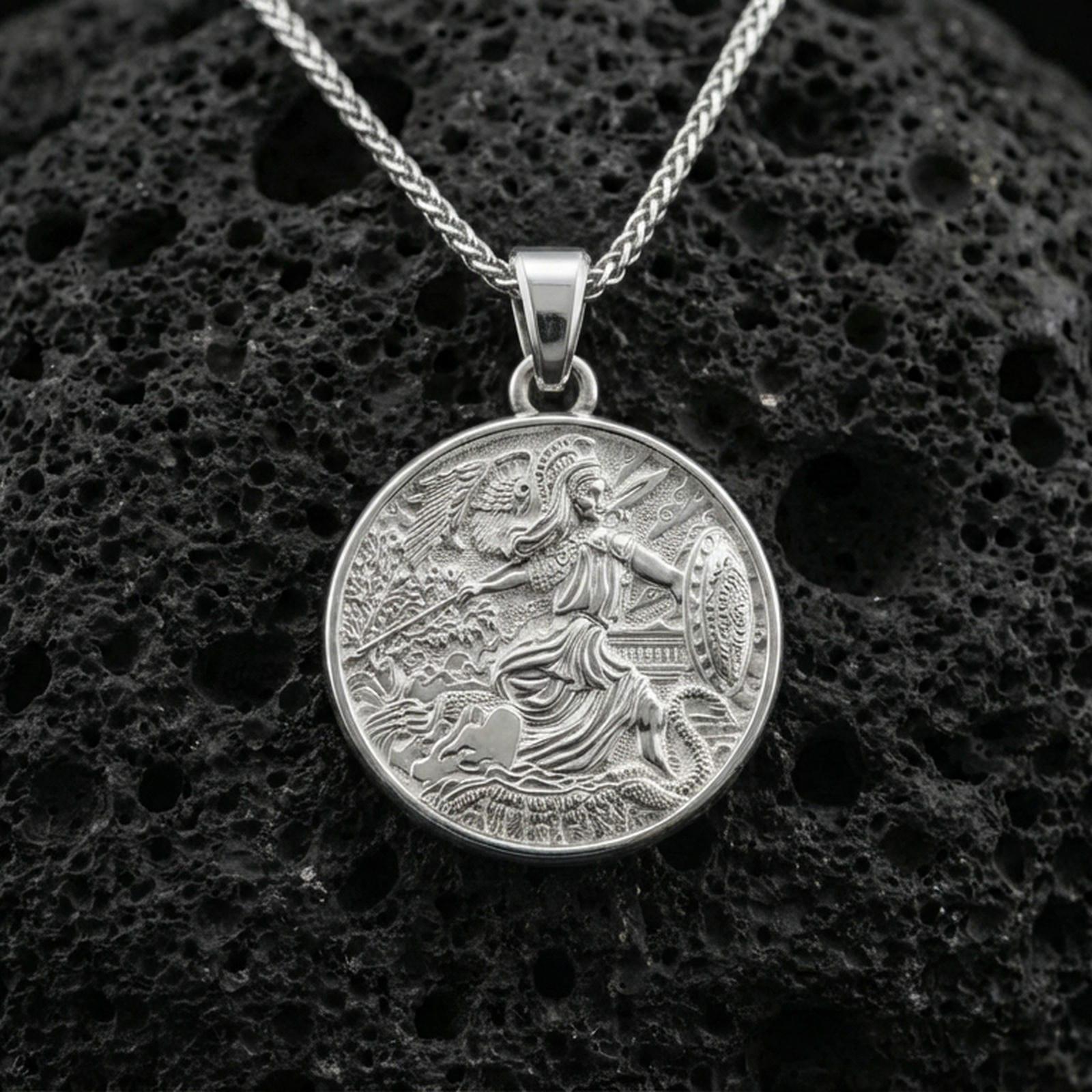 Polished silver Athena coin pendant on porous volcanic stone, Greek goddess warrior medallion necklace with shield and serpent details