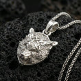 Load image into Gallery viewer, Polished silver Fenrir wolf head pendant on porous volcanic stone, Viking wolf necklace with intricate Celtic knots and Nordic symbolism
