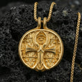 Load image into Gallery viewer, Gold plated ankh pendant on volcanic rock, Eye of Providence medallion with Egyptian motif, premium engraved background and bold ankh design
