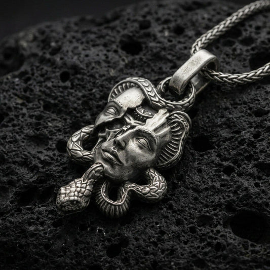 Oxidized 925 sterling silver Medusa skull pendant on volcanic rock, snake-wrapped memento mori necklace with detailed gothic face relief