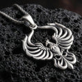 Load image into Gallery viewer, Oxidized 925 sterling silver phoenix pendant on volcanic rock, openwork wings design with sculpted feather layers
