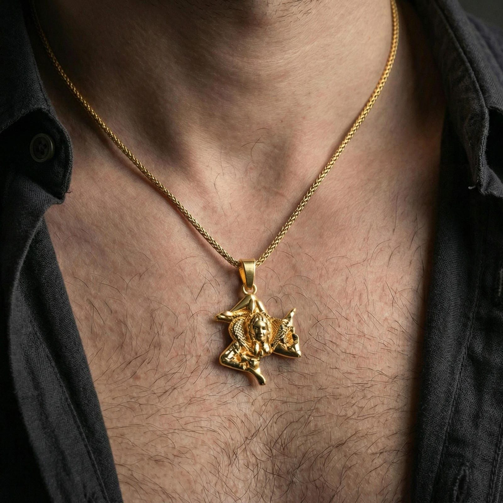 Gold plated trinacria pendant worn on neck, sicilian triskelion medusa necklace bright shine and premium texture
