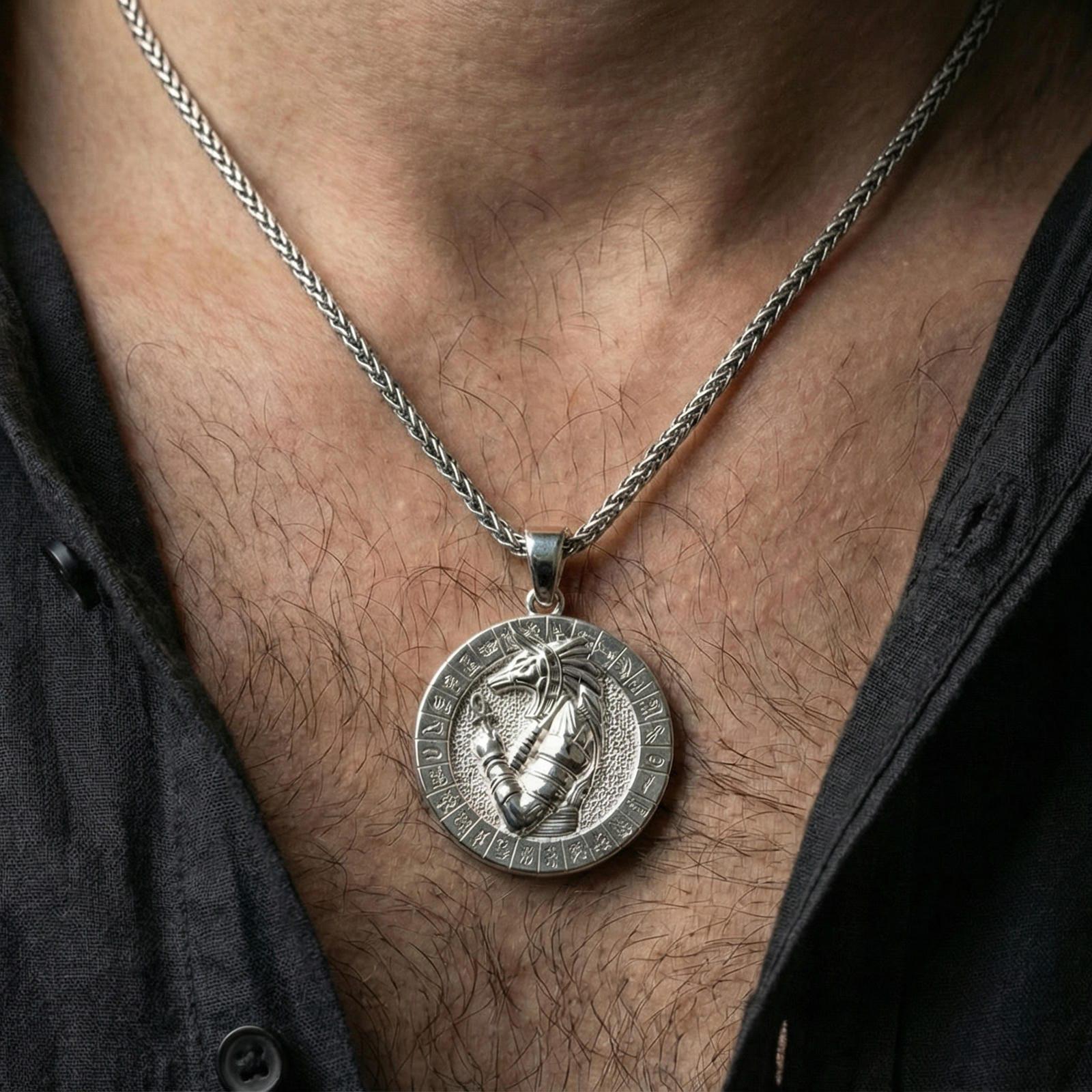 Polished silver Anubis necklace worn on neck, round Egyptian pendant with hieroglyph border and crisp relief