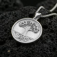 Load image into Gallery viewer, Polished silver Tree of Life medallion on porous volcanic stone, round coin pendant with detailed bark texture
