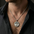Load image into Gallery viewer, Polished silver Tree of Life medallion worn on neck, minimalist coin pendant with strong botanical symbolism
