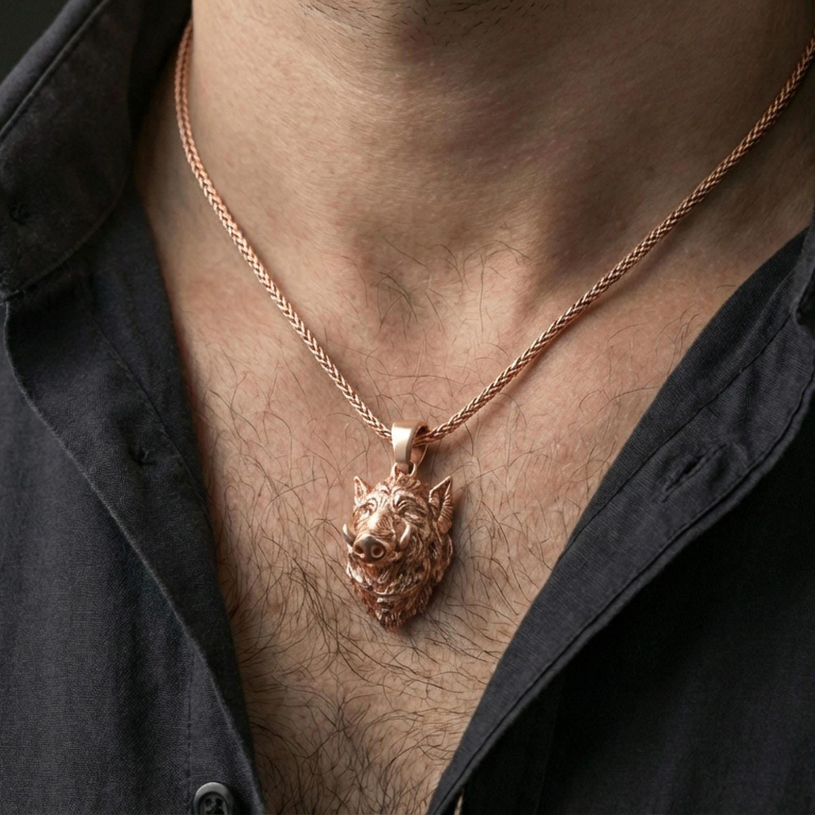 Rose gold plated boar head pendant necklace on the neck, close-up lifestyle photo showcasing the warm tone and intricate boar head relief