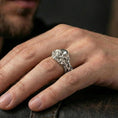 Load image into Gallery viewer, Polished silver skull vine ring worn on the finger, wearable photo highlighting reflective finish, crisp skull teeth detail and braided vine band

