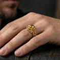 Load image into Gallery viewer, Rose gold plated skull and vine ring worn on a finger, close-up lifestyle photo showcasing warm finish, intertwined vine texture and detailed skull face
