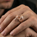 Load image into Gallery viewer, Rose gold plated filigree skull ring worn on a finger, close-up lifestyle shot focusing on the sculpted skull and detailed engraving
