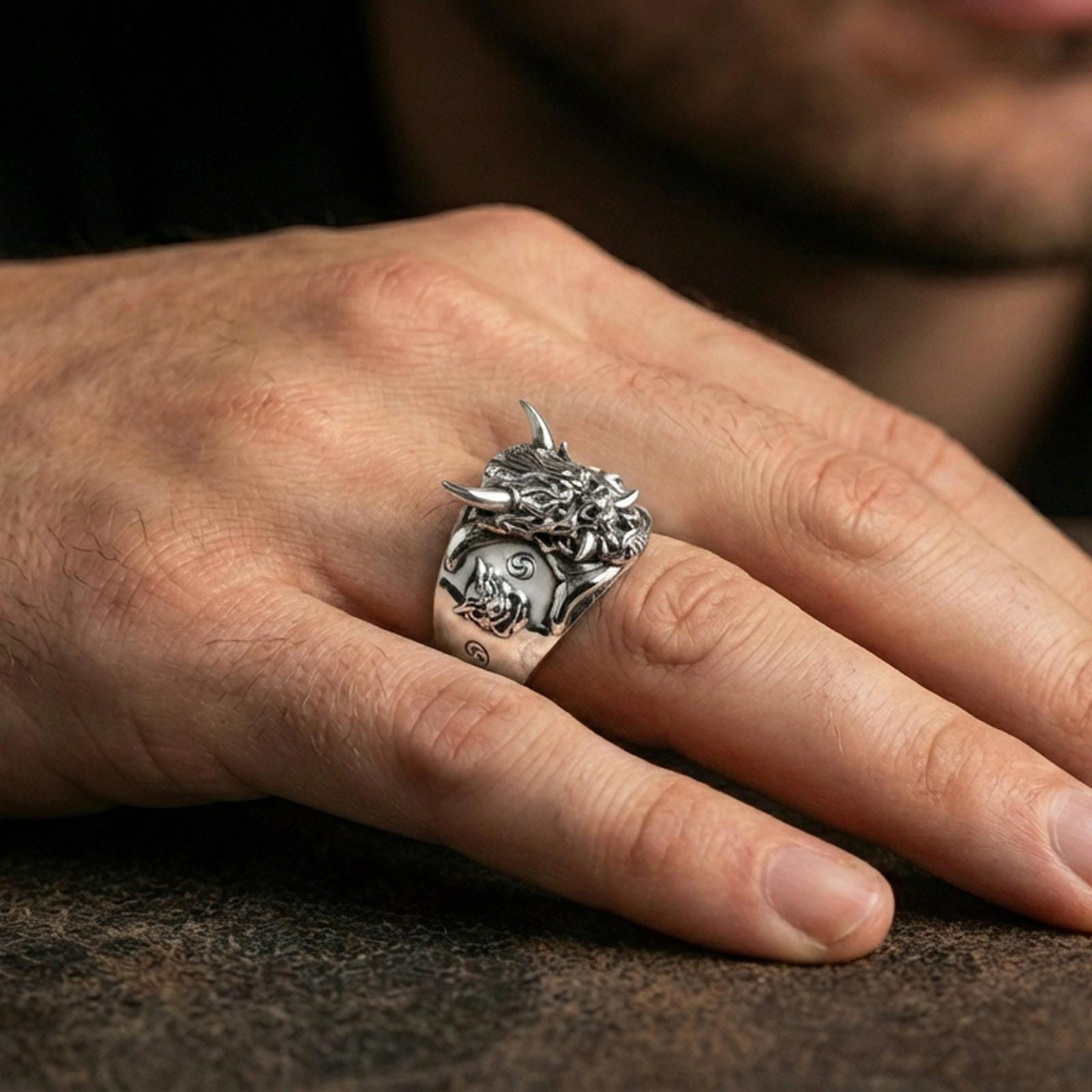 Polished silver Japanese Oni ring on the finger, wearable shot emphasizing sharp carving, horns, and bold statement profile